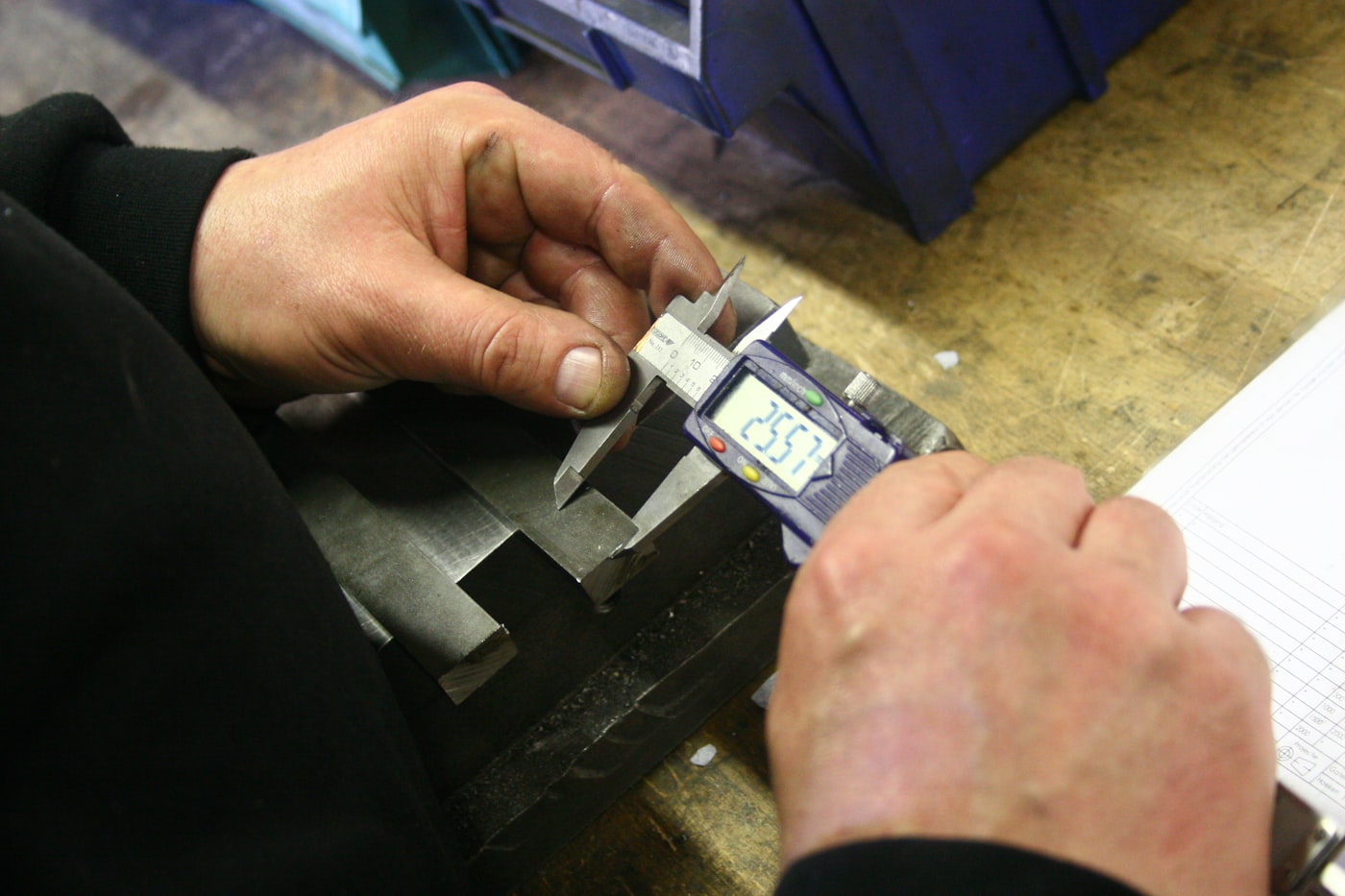 Quality inspector examining product against specification